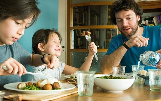 french family sitting at the table eating french foods