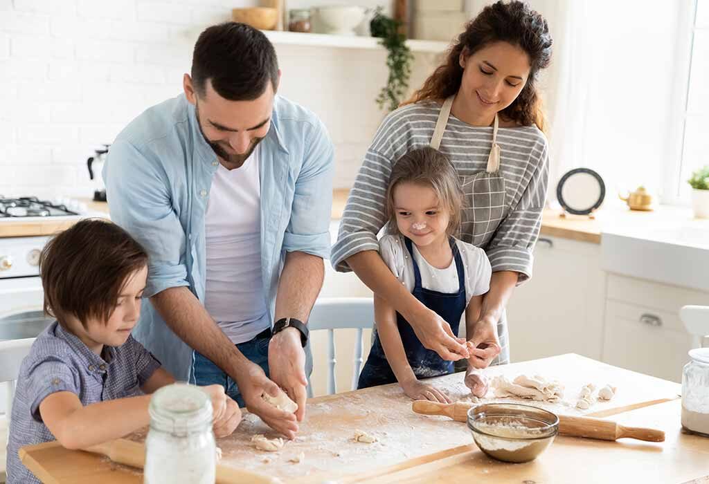 mother and father showing there two children how to bake